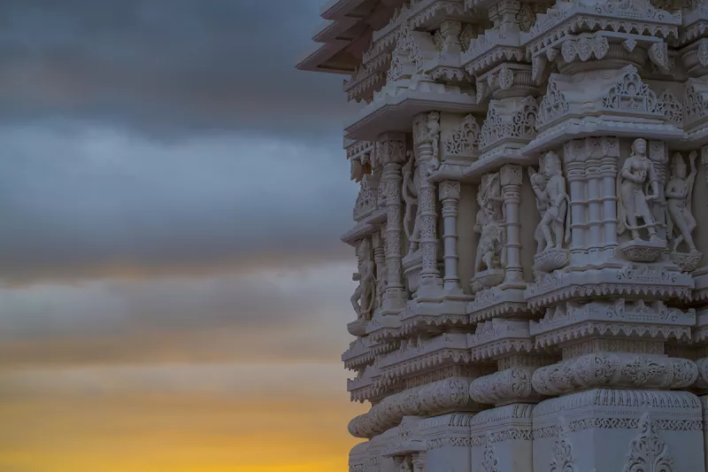 Carvings on mandir with sunrise