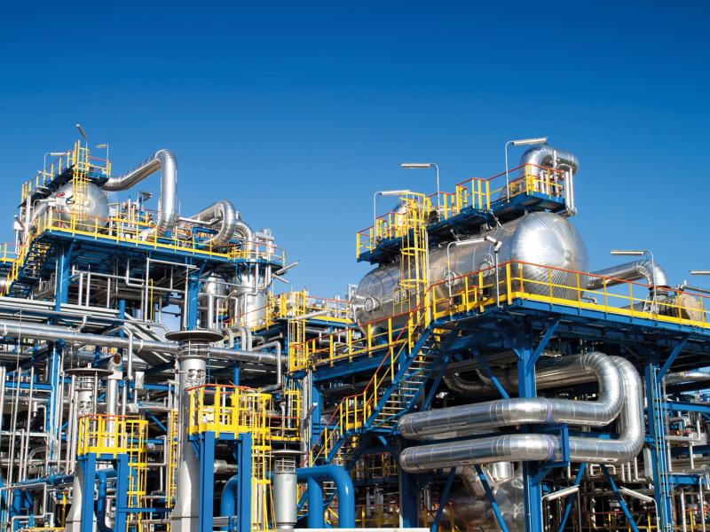 Oil refinery plant with blue sky in the background. 