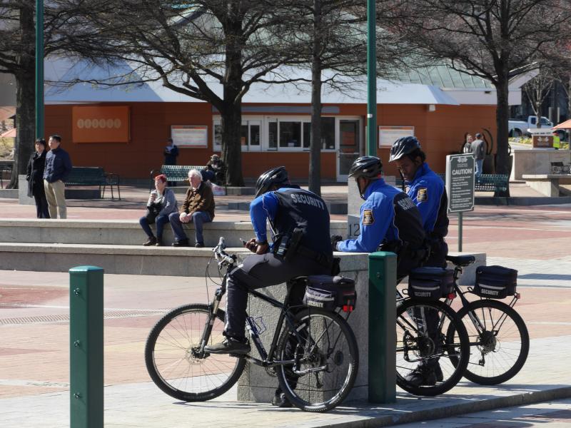 Three Atlanta Police officers on bike patrol congregate on city street