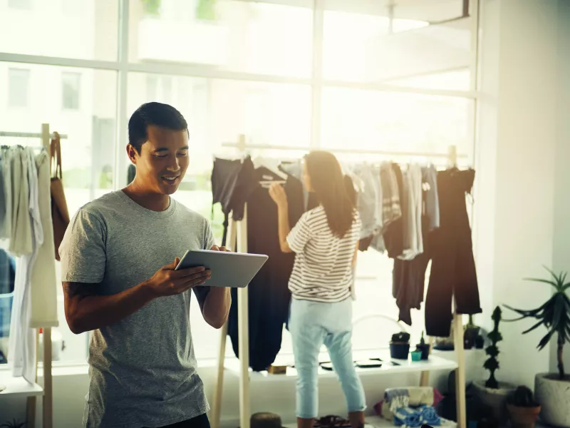 man holding a tablet, in a retail store environment