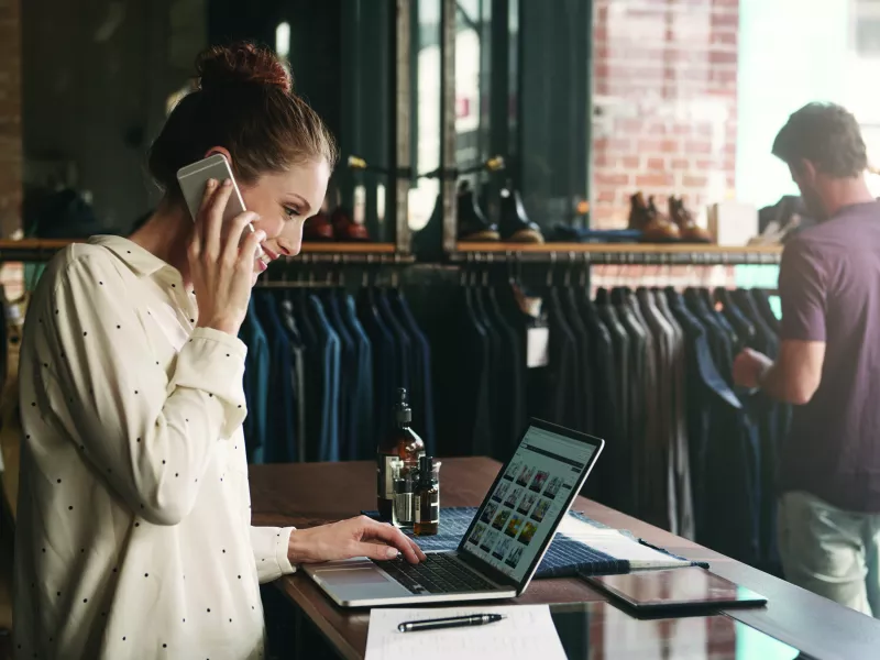 retail owner in a clothing store, in a phone call