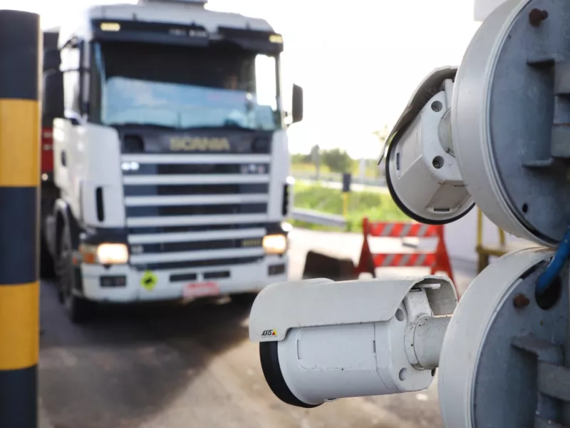 Truck entering port with cameras in foreground