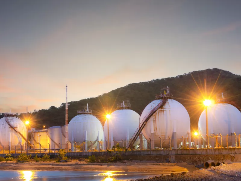 Critical infrastructure area with gas tanks in the sunset.