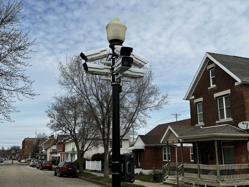 Light pole on city street with cameras mounted