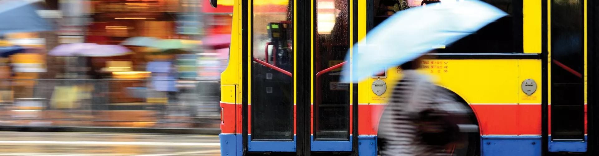 Blurry picture of bus passing by on a street